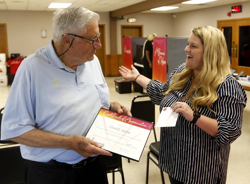 U.S. Army veteran Harold Walter, of Fox Lake, is presented with a 20-gallon pin by Emily Alanis  as he donates blood Monday, Sept. 18, 2023, during, a Versiti Blood Drive at the McHenry VFW Post 4600. Walter, who turns 90 years old this week, has donated over twenty gallons of blood.
