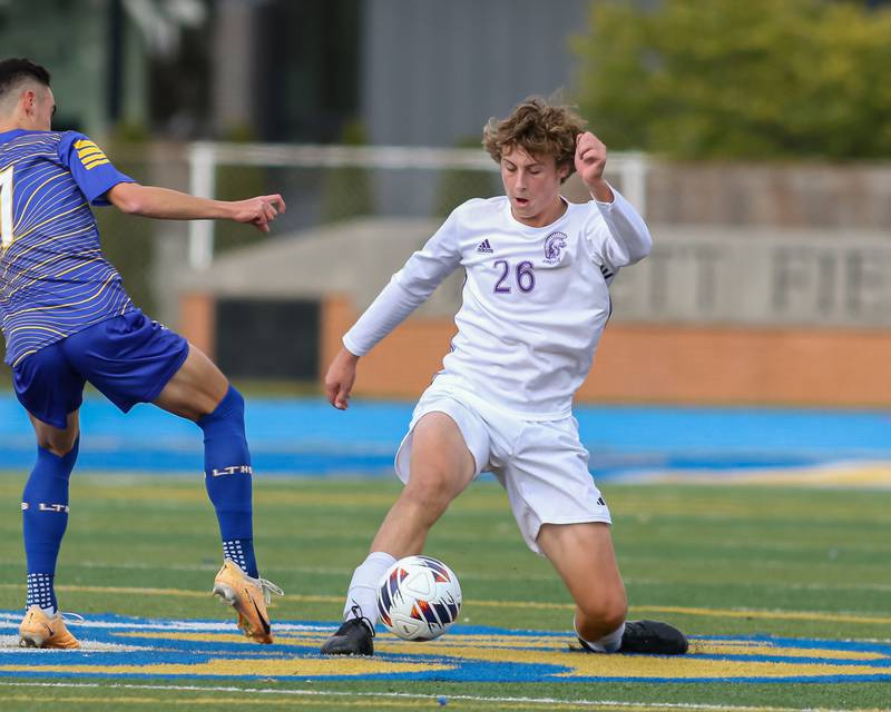 Downers Grove North's Ben Llewellyn (26) kicks the ball away from Lyons Mason Burda (7) during Class 3A Lyons Regional final soccer match.  Oct 21, 2023.