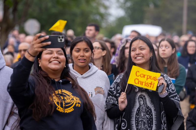 Procession participants take a selfie as they walk from St. Hyacinth Church to the Queen of the Holy Rosary Shrine on May 19, 2025, in La Salle.