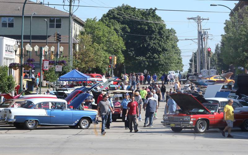 Crowds of people check out the vintage cars on South California Street in Sycamore Sunday, July 31, 2022, during the 22nd Annual Fizz Ehrler Memorial Car Show. Most of downtown Sycamore was filled with classic cars for the show.