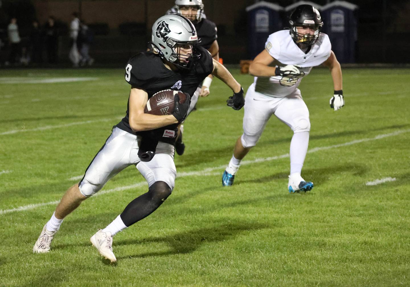 Kaneland's Carter Grabowski carries the ball as Sycamore's Ethan Keicher gives chase during their game Friday, Oct.4, 2024, at Kaneland High School in Maple Park.