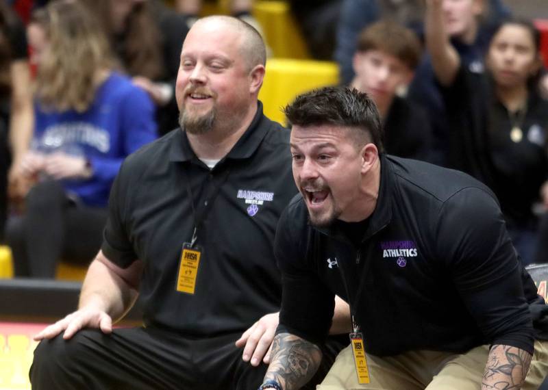 Hampshire’s coaches guide Samantha Diehl in her bout against Schaumburg’s Nadia Razzak at 190 pounds of varsity girls IHSA Sectional wrestling on Saturday, February 14, 2026, at Schaumburg High School in Schaumburg.