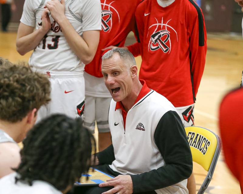 Bradley-Bourbonnais's head coach Ryan Kemp draws up a play during a timeout in their WJOL Thanksgiving Classic Championship game between Bradley Bourbonnais at Lemont, Saturday November 30, 2024  in Joliet.