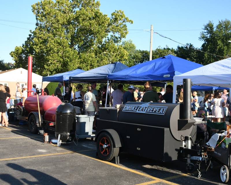 Smokers sit behind the tents of competitors who put their grilling to the test on Sunday Sep. 1, 2024, during the Cue for a Cause event in downtown Elmhurst.