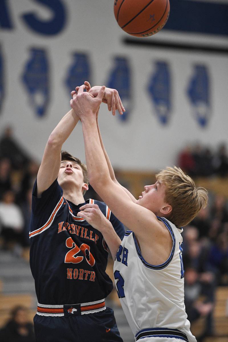 Naperville North’s Grant Montanari and St. Charles North’s Parker Reinke compete for a rebound in a boys basketball game in St. Charles on Wednesday, January 18, 2023.