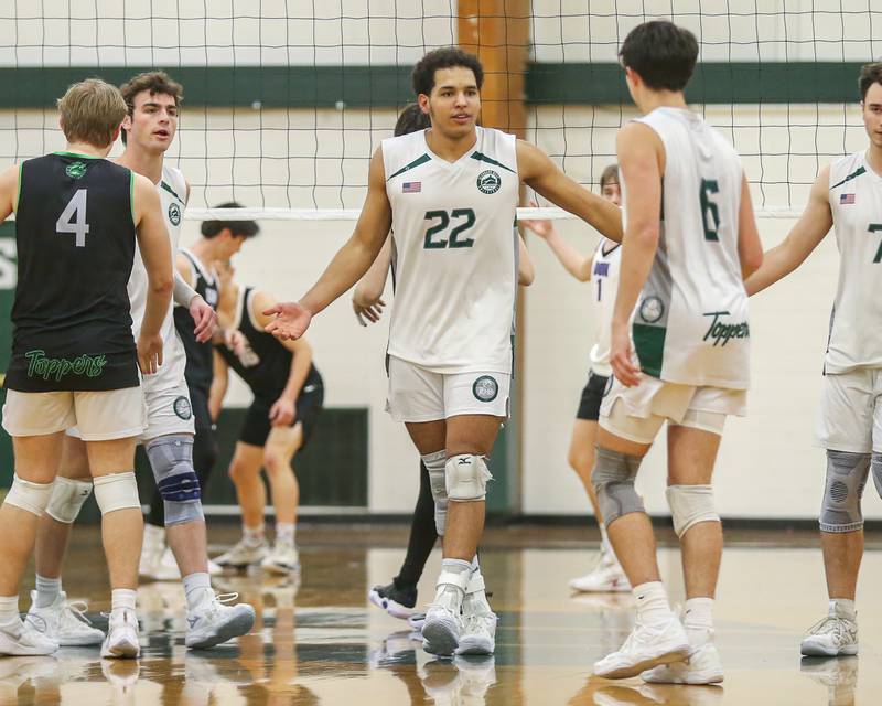 Glenbard West's Xzavion Willett (22) celebrates a point with teammates during volleyball match between Downers Grove North at Glenbard West.  April 2, 2024.