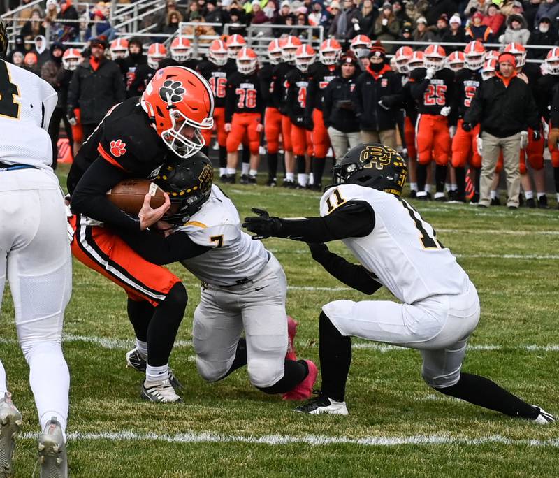 Byron senior quarterback Braden Smith churns his legs for a touchdown while being wrapped up by Reed-Custer's Josh Bohac during Saturday's Class 3A Quarterfinal Playoff game in Byron