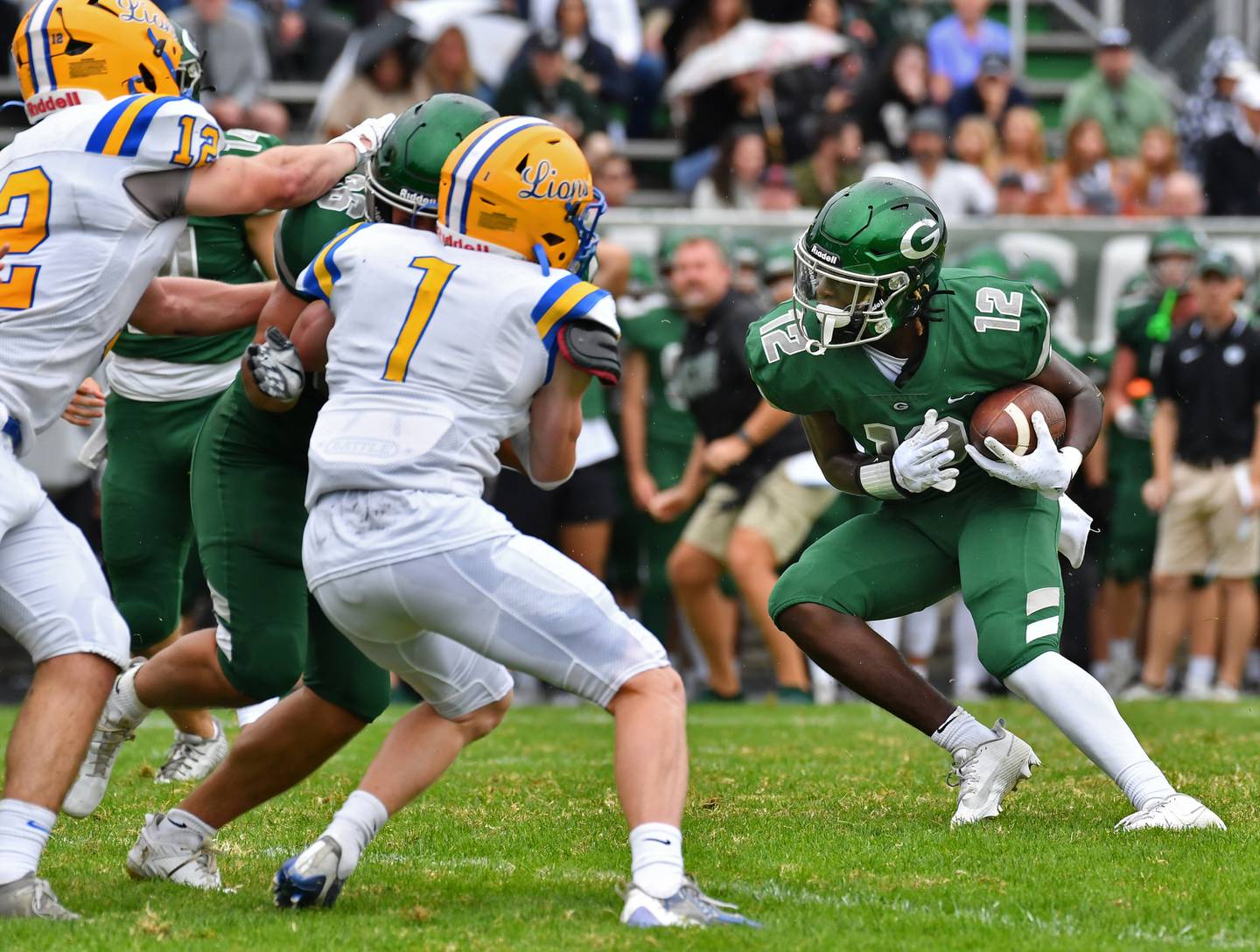 Glenbard West's Teyoin Oriental (12) looks for hole in the Lyons Township defense during a game on Sep. 16, 2023 at Glenbard West High School in Glen Ellyn.