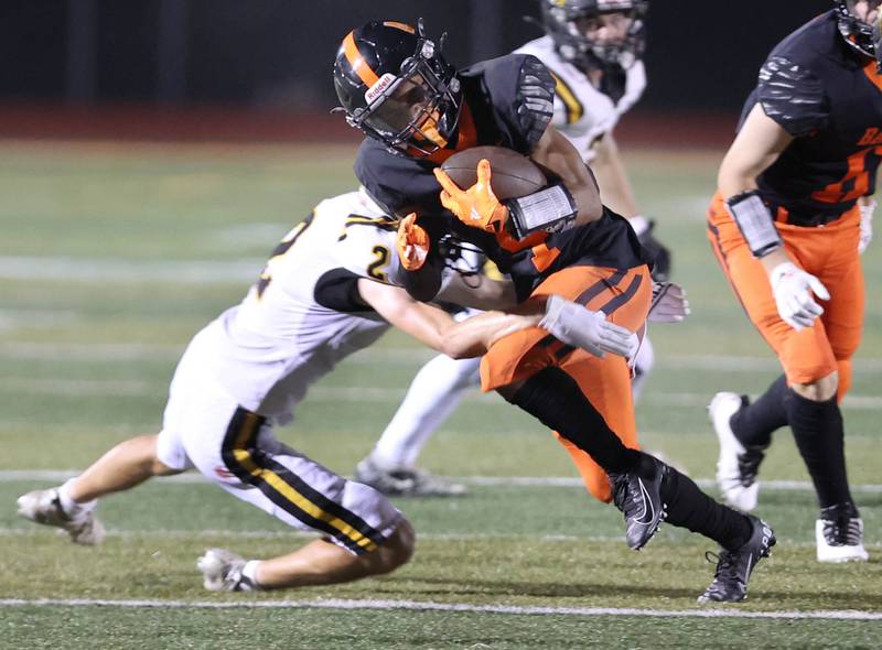 DeKalb's Xavier Dandridge is brought down by Metea Valley's Robert Lynch during their game Friday, Sept. 16, 2022, at DeKalb High School.