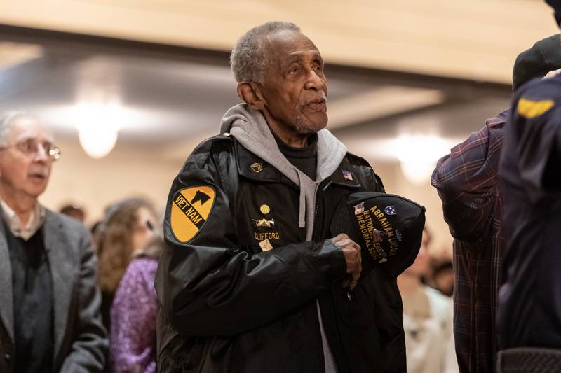Army veteran Clifford Lauderdale holds his hat over his heart as the National Anthem is played during the Veterans Day Assembly at Joliet Central High School on Nov. 7, 2025.