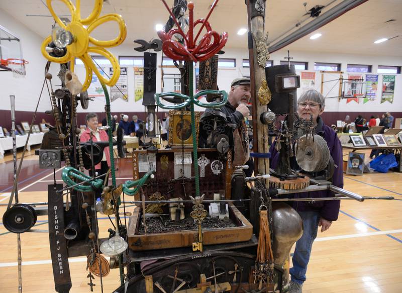 Artist Randell Richey of Westmont discusses his metal cross making with Marcia Cox during the Art Show held at the Westmont Community Center Sunday March 19, 2023.