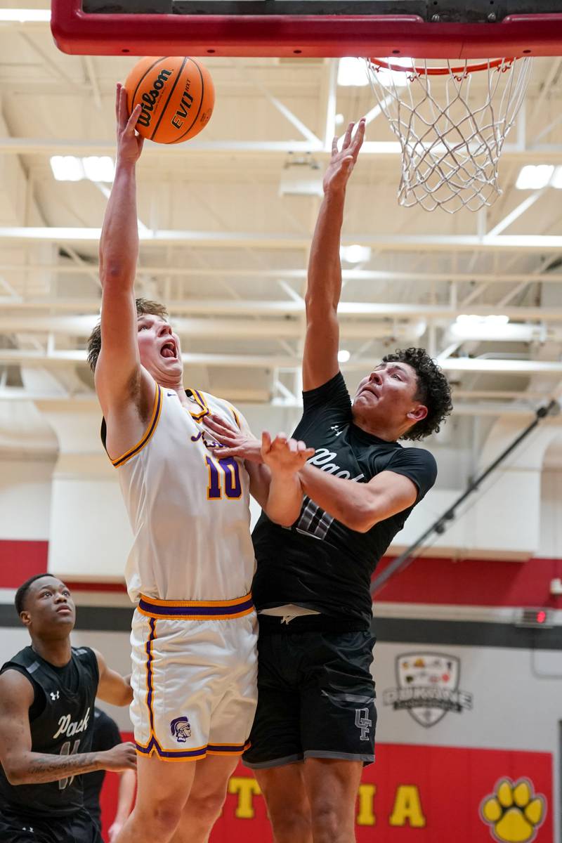 Downers Grove North's Bobby Grganto (left), shoot the ball in the paint over Oswego East's Damien Lewandowski during a Batavia Night of Hoops Basketball game at Batavia High School on Saturday, Jan. 25, 2025.