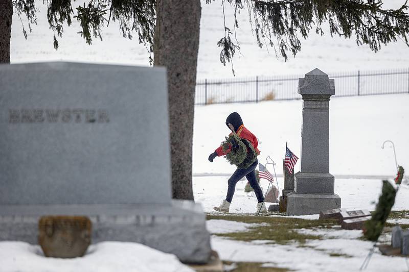 Elise Ulferts-Hume works to place wreaths Saturday, Dec. 13, 2025, in Dixon.