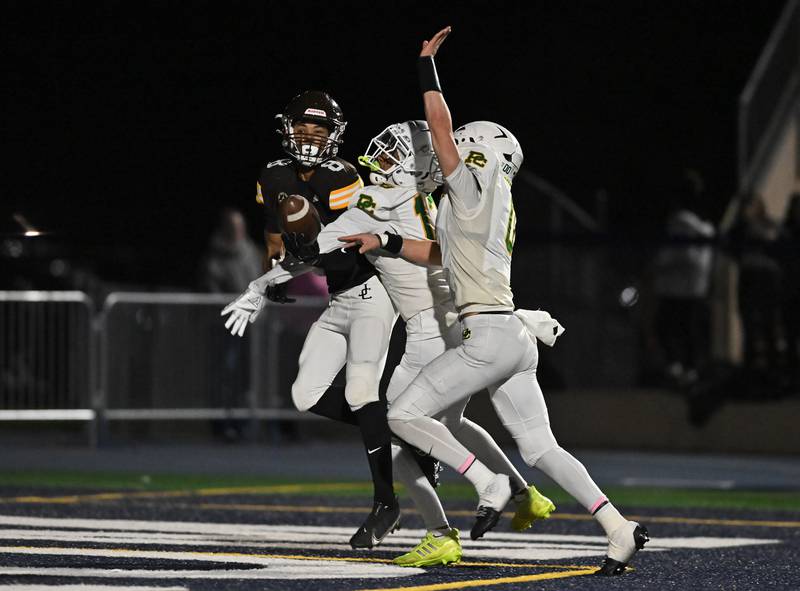 Providence Catholic's defenders covering Joliet Catholic's Michael Brown (8) on a deep pass during the conference game on Friday, OCT. 24, 2025, at Joliet.