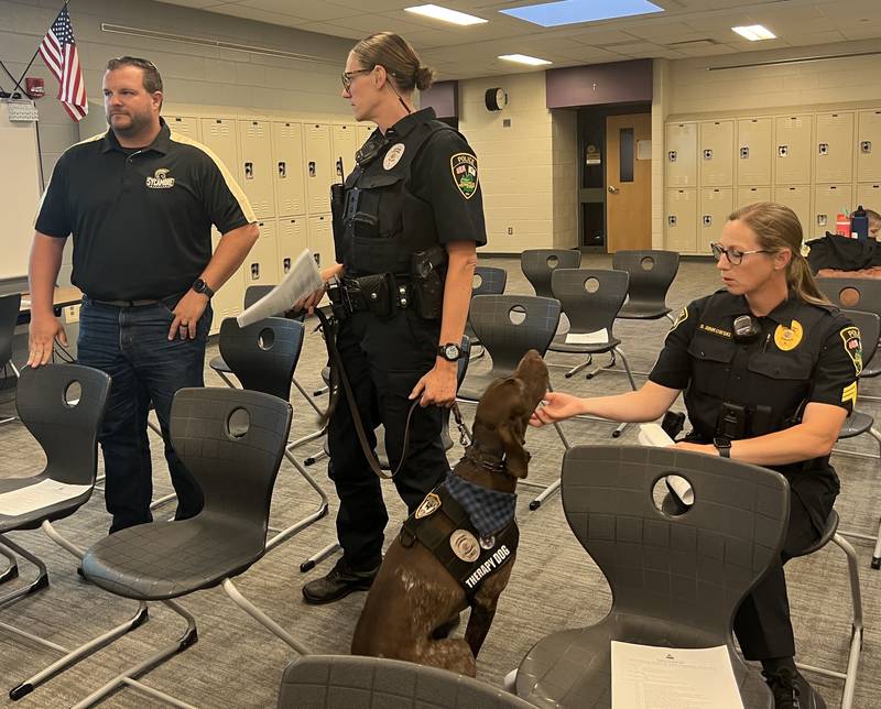 Dooley, a German Shorthaired Pointer, a Sycamore police therapy dog handled by school resource officer Kaitlyn Pederson gets scratches from Pederson's supervisor Sergeant Stacey Binkowski on June 24, 2025.  They were at Sycamroe Middle School so that Pederson and fellow school resource officer Daniel Ludwig could present their annual report to the Sycamore board of education.