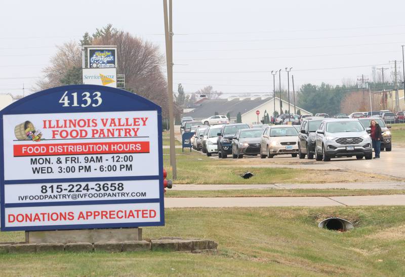 A long line of cars wait for orders on Progress Boulevard during the Thanksgiving Distribution on Wednesday, Nov. 19, 2025 at the Illinois Valley Food Pantry in Peru. Nearly 500 families or roughly 1,200 people in the Illinois Valley got a Thanksgiving meal.