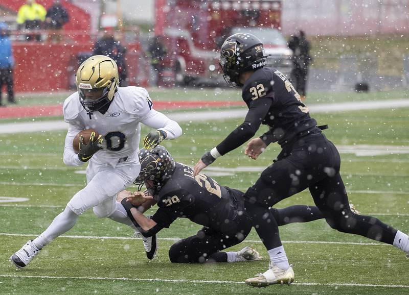 Althoff Catholic’s Dierre Hill Jr. avoids a tackle by Lena-Winslow's Miles Mahon Friday, Nov. 29, 2024, in the class 1A football state final.