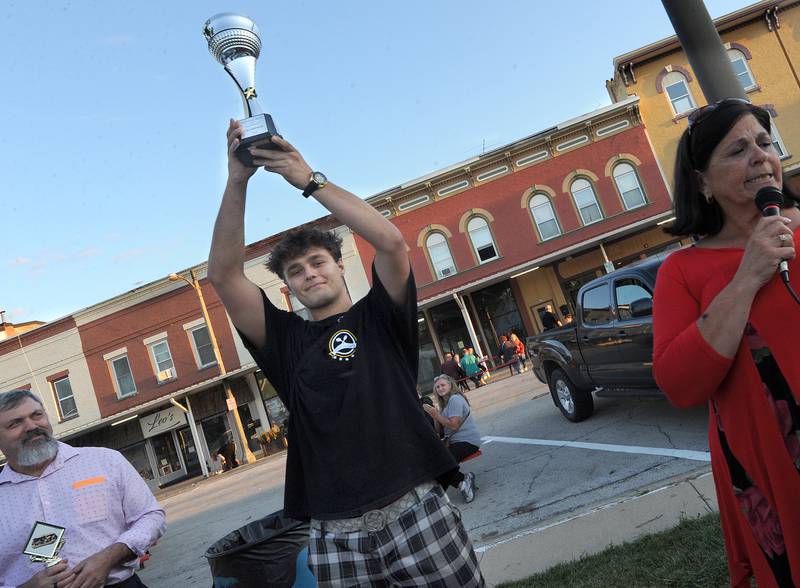 After winning the Best Sandwich in Sandwich award, Star 34 Cafe owner Larry Aliu, holds the trophy high during the Taste of Sandwich, Wednesday, Sept. 25, 2024, in downtown Sandwich.