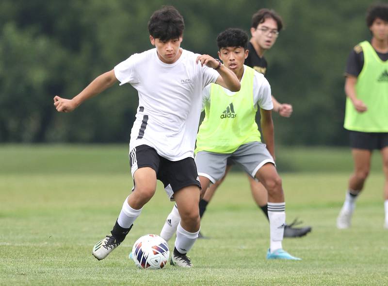 Sycamore’s Liam Tran (left) controls the ball during a scrimmage at practice Wednesday, August 9, 2023, at Sycamore High School.