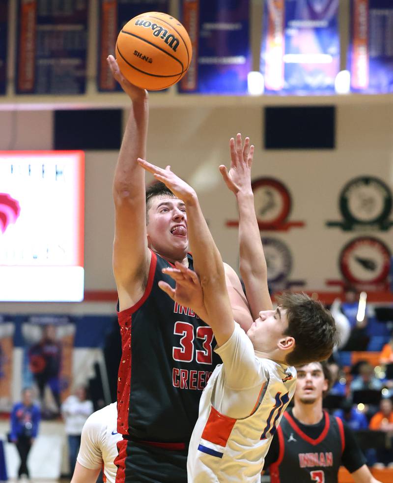 Indian Creek's Payton Hueber shoots over Genoa-Kingston's Benjamin Kleba during their game Friday, Jan. 2, 2026, at Genoa Kingston High School.