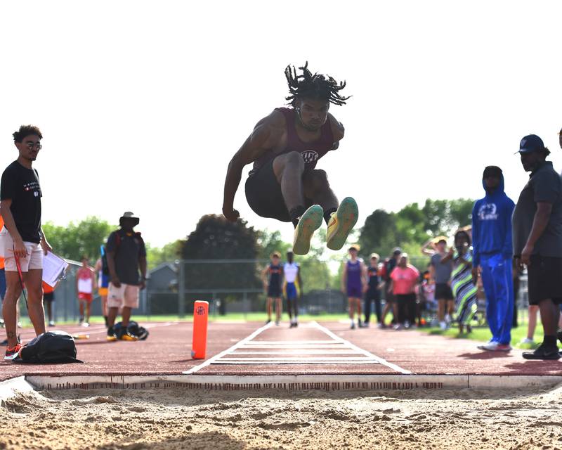 Lockport's Jalen Falcon soaring during the long jump event at the IHSA Sectionals on Thursday, May. 19, 2022, at Lockport.