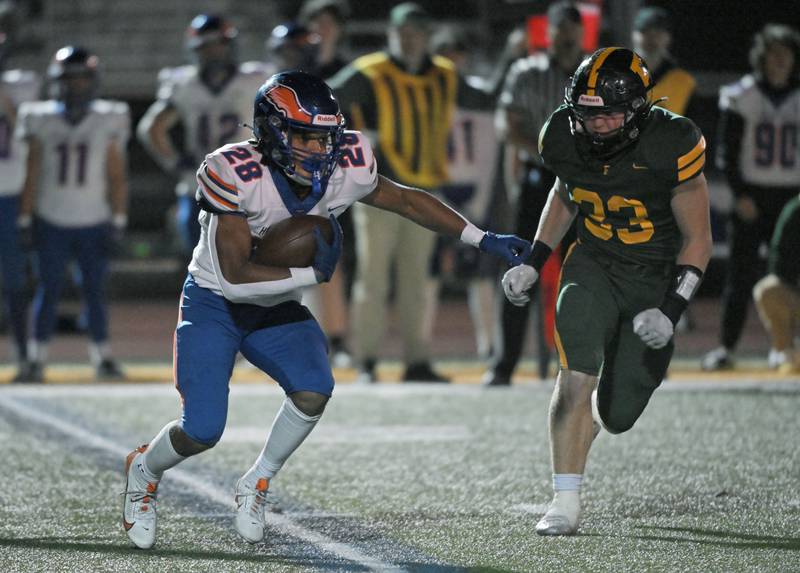 Hoffman Estates’ Landon Ford tries to get around Fremd’s Matt Klimas in a football game in Palatine on Friday, Sept. 27, 2024.
