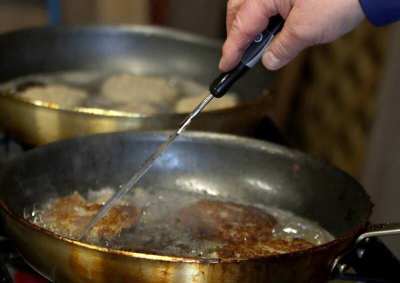 Latkes are fried during a Chanukah party at The McHenry County Jewish Congregation Sunday.