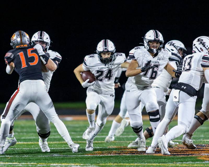 Plainfield North's Jameson Wiers (24) runs up the middle during football game between Plainfield North at Minooka.   Oct 6, 2023.