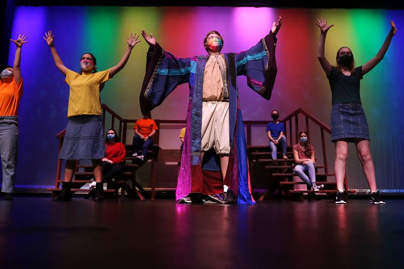James Mihevc, center, performs the song "Any Dream Will Do" from the musical Joseph and the Amazing Technicolor Dreamcoat during a dress rehearsal for their upcoming performance of "Musical Revue" at McHenry High School West Campus on Thursday, March 4, 2021 in McHenry.  The musical opens on Friday, March 12 at 7pm, and will have performances on Saturday, March 13 at 4:30pm and 7pm, Sunday, March 14 at 3pm, Friday, March 19 at 7pm, and Saturday, March 20 at 7pm. All performances will be in-person at the theater under reduced capacity of 50 spectators.