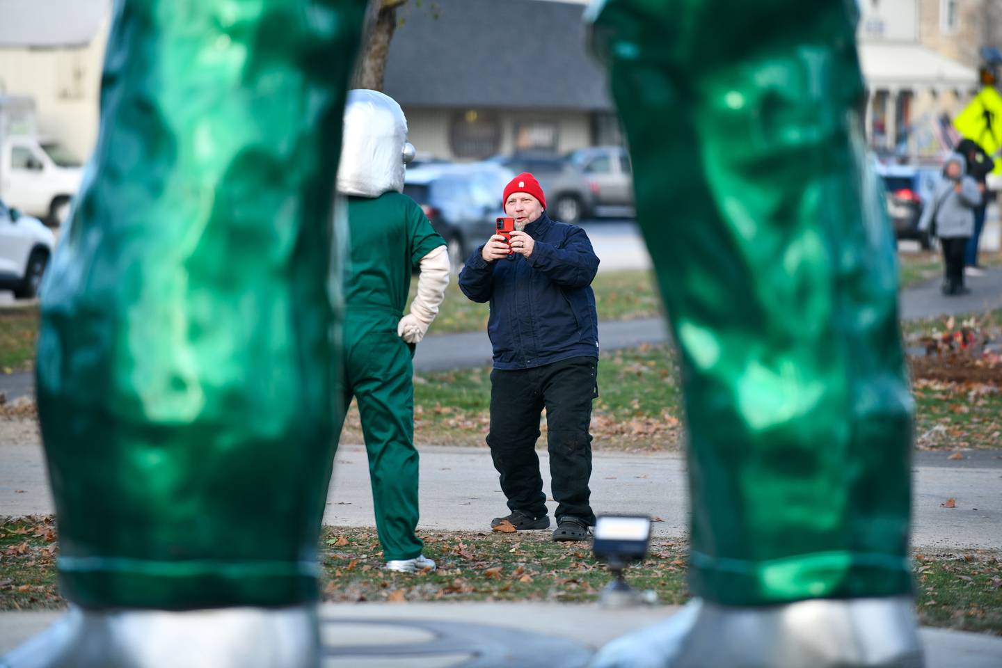 Dean Thacker, of Wilmington, takes a photo of a Gemini Giant mascot in front of the resurrected statue Saturday during the Gemini Giant Homecoming event at Wilmington's South Island Park.