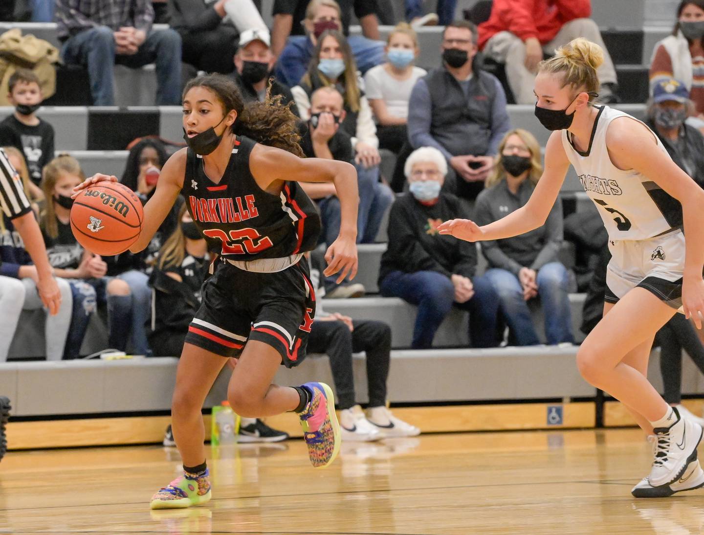 Yorkville's Alex Stewart (22) drives the ball down the court past Kaneland's Taylor Seaton (5) during a game in Maple Park on Wednesday, December 15, 2021.