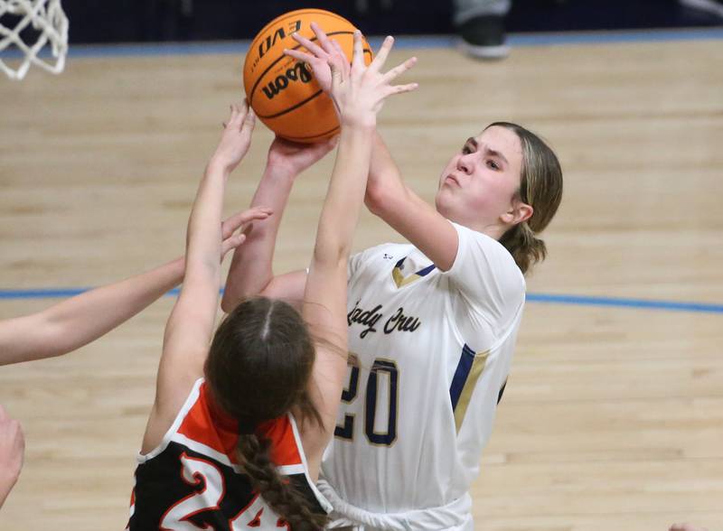 Marquette's Kaitlyn Davis drives to the hoop as Roanoke-Benson's Josie Weber defends on Thursday, Feb. 6, 2025 in Bader Gym at Marquette High School.