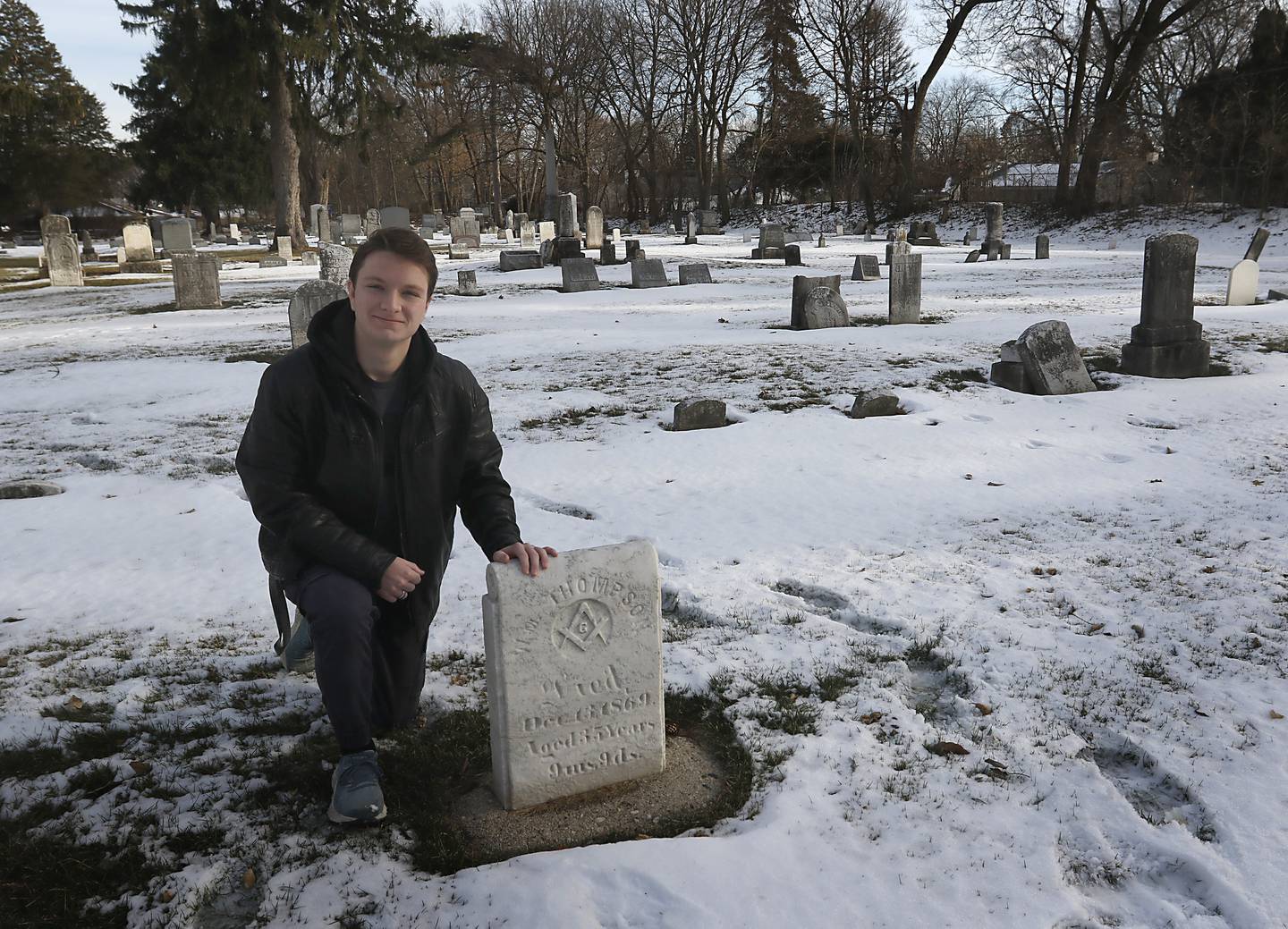 Mitchell Hopkins with a veteran's headstone that he restored for an Eagle Scouts Project in the Crystal Lake Cemetery on Lake Avenue. The Crystal Lake Historic Preservation Commission has created a book, titled "Remembering Those Who Served,” documenting the lives of all 54 veterans since 1840 who are buried at the cemetery.