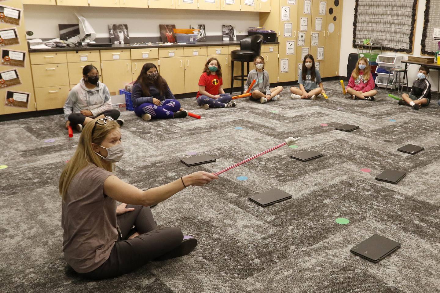 Coventry Elementary School music teacher Kendra Chatham uses a pointer to signal for students, sitting in a socially distant circle around the room, to play their instrument during in-person learning at Coventry Elementary School on Wednesday, Sept. 29, 2021 in Crystal Lake.