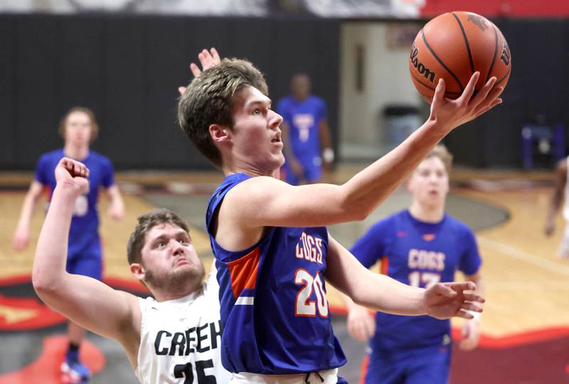 Genoa-Kingston's Nathan Skarzynski shoots a layup in front of Indian Creek's Jake Taylor Wednesday, Jan. 25, 2023, during their game at Indian Creek High School in Shabbona.