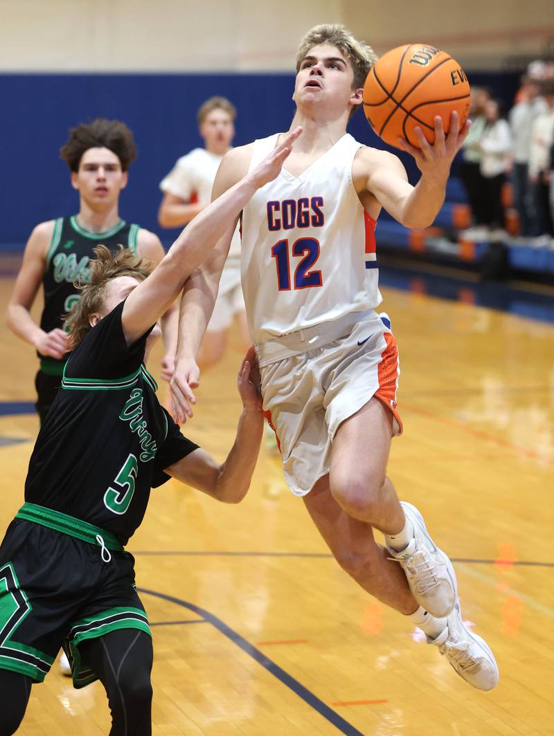 Genoa-Kingston's Blake Ides goes to the basket against North Boone's Collin McKibben during their Class 2A regional game Monday, Feb. 24, 2025, at Genoa-Kingston High School.