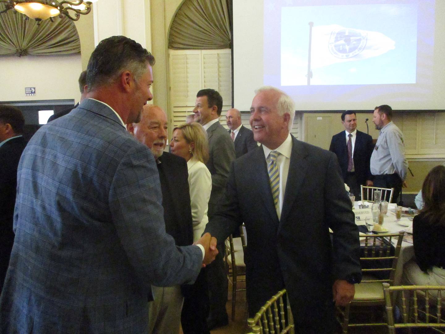 Joliet Mayor Terry D'Arcy (right) greets well-wisher Bill Przybylski after his State of the City speech on Wednesday. May 28, 2025
