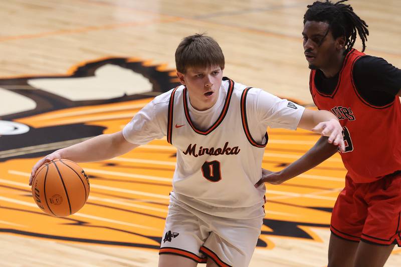 Minooka’s Rhett Harris makes a move against Bolingbrook on Tuesday, Dec. 17, 2024 in Minooka.