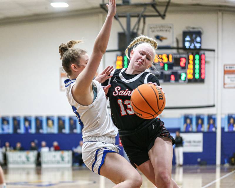 Saint Charles East's Keira Hansen (3) collides with Lyon's Avery Mezan (20) on the baseline during their Coach Kipp's Hoopfest basketball game between Lyons at St Charles East. Jan 18, 2025 in La Grange.