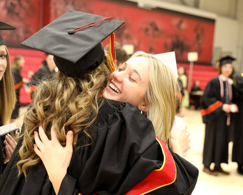 Batavia High School graduate Caroline Schroeder hugs a friend before the school’s 2023 commencement ceremony at Northern Illinois University in DeKalb on Wednesday, May 24, 2023.