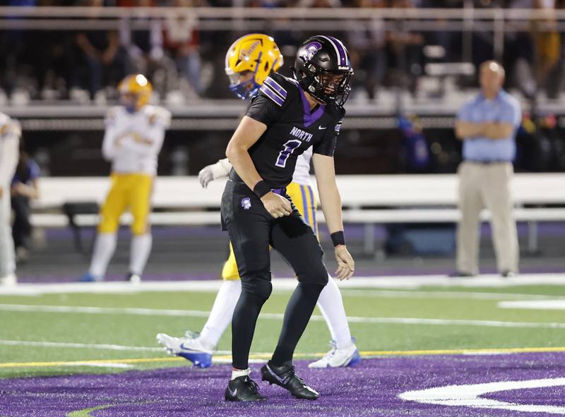 Downers Grove North's Owen Kansu (1) comes off the field favoring his left shoulder after being tackled by the Lyons' defense during the varsity football game between Downers Grove North and Lyons Township on Friday, Oct. 11, 2024 in Downers Grove.