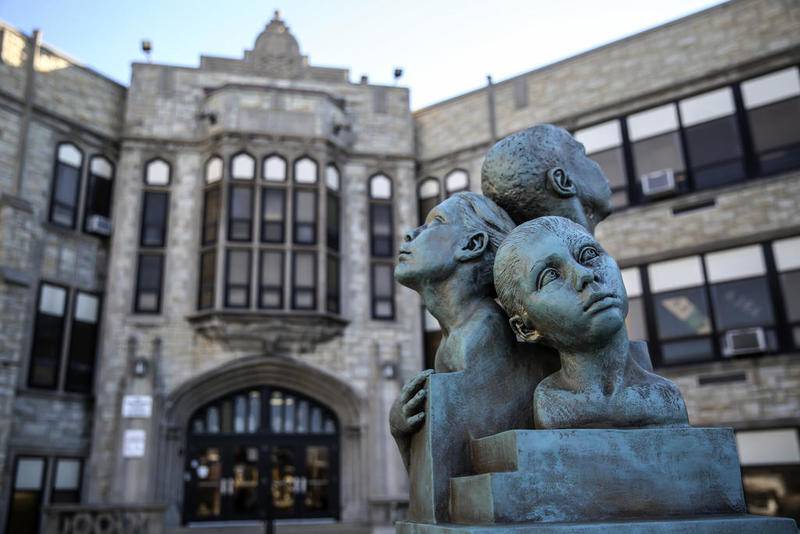 A statue depicting several children stands near the entrance of Washington Junior High School on Thursday, Dec. 6, 2018, at in Joliet, Ill.