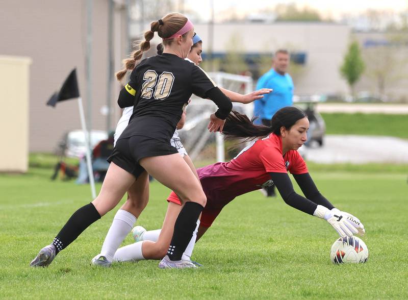 Kaneland's Liliana Guzman makes a save under heavy pressure from Sycamore's Cortni Kruizenga during their game Wednesday, April 29, 2026, at Sycamore High School.