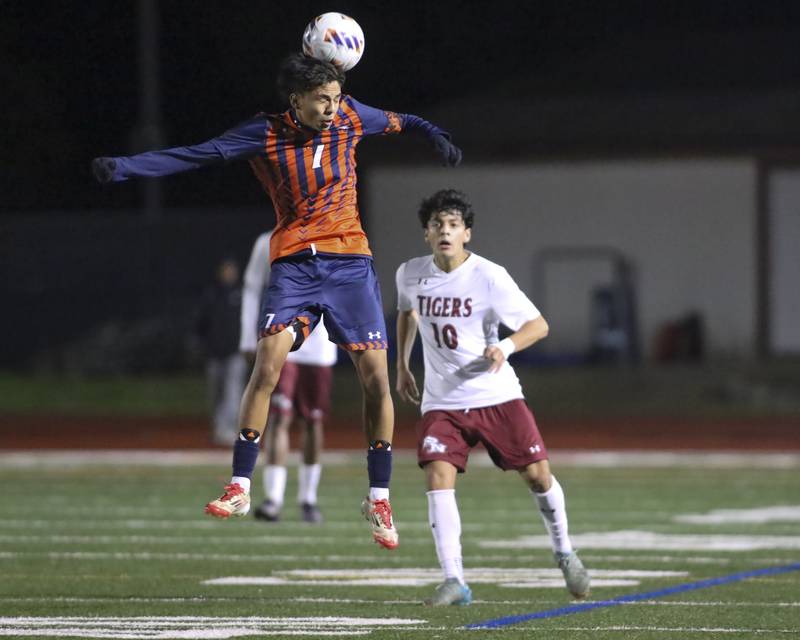 Oswego's Enrique Castañeda (7) heads the ball during Class 3A Naperville Central Regional semifinal soccer match between Plainfield North at Oswego, Tuesday Oct 21, 2025.