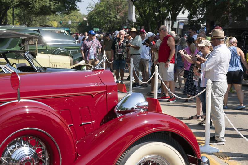 Crowds gather to view classic cars during  the 2024 Geneva Concours d'Elegance on Sunday, August 25, 2024 in downtown Geneva. Car enthusiasts gathered along Third Street to display classic, antique and modern automobiles.