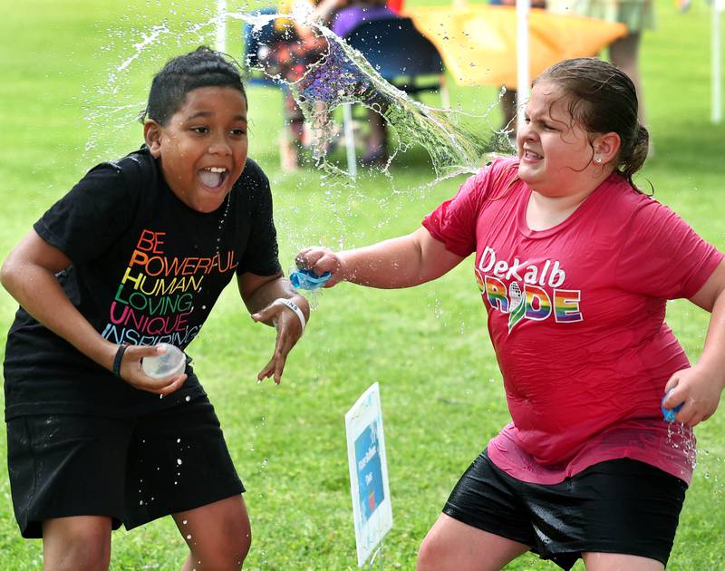 Ezra Jackson, 10, from DeKalb, gets splashed by Leila Thompson, 7, from DeKalb, during the Pride Palooza Friday, May 30, 2025, at Bethlehem Lutheran Church in DeKalb. The event was hosted by Family Service Agency of DeKalb County and Youth Outlook.
