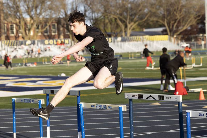 Rock Falls’ Rian Bender clears the hurdle in the low hurdle shuttle Thursday, April 25, 2024 at the Sterling High School Night Relays.