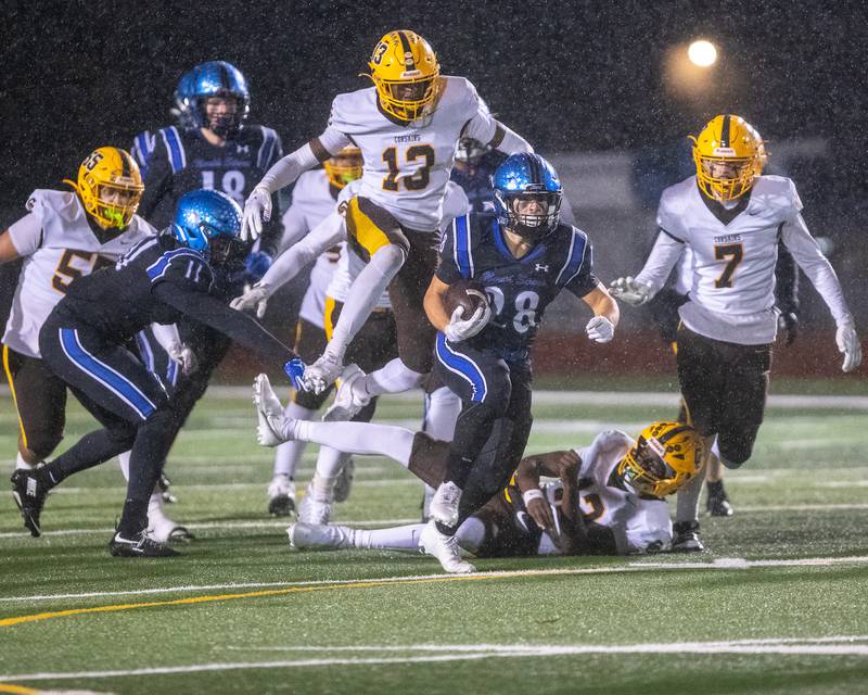 St. Charles North's Carsen Durante runs the ball past Carmel's defense  at the Class 7A Second Round playoff game on Saturday, Nov.8,2025 in St. Charles.