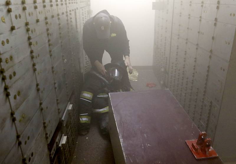 McHenry Fire Department instructor Kevin Sears prepares an injured firefighter training exercise on Tuesday April 15, 2025, during a RIT crew and chief divisional drill with other firefighters from area departments in a former bank building in Downtown McHenry.