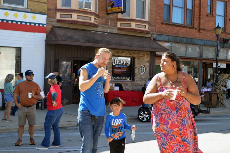 Shay Dault (right), Robbie Dault and 4-year-old Dillyn Dault, all of Polo, walk through the Polo Chili Cook-Off and Block Party on Saturday, Sept. 28, 2024, in downtown Polo.